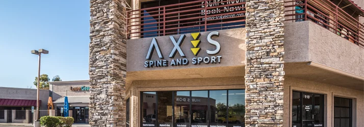 The sign at the front exterior of Axis Spine and Sport - Tempe