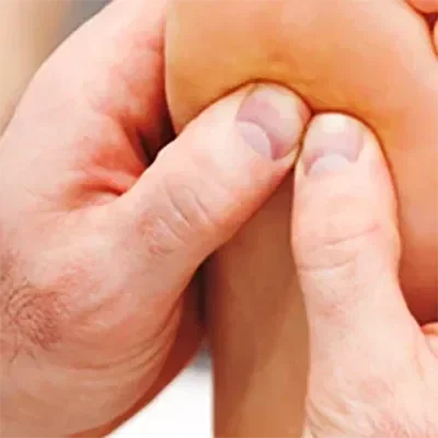 A practitioner examining a patient's foot