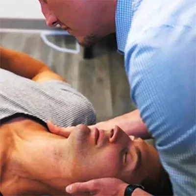 A patient receiving a chiropractic adjustment to the neck